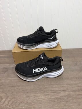 Used women Hoka Bondi 8 running shoes in the black and white size 8.5